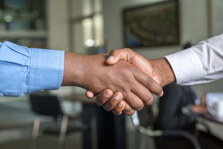 Handshake between a homeowner and builder after agreeing a quote