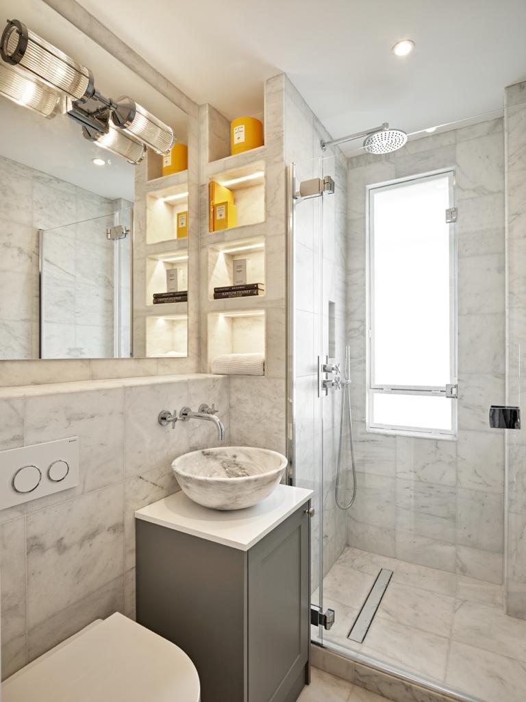 Marble-tiled bathroom with stone basin and walk-in shower