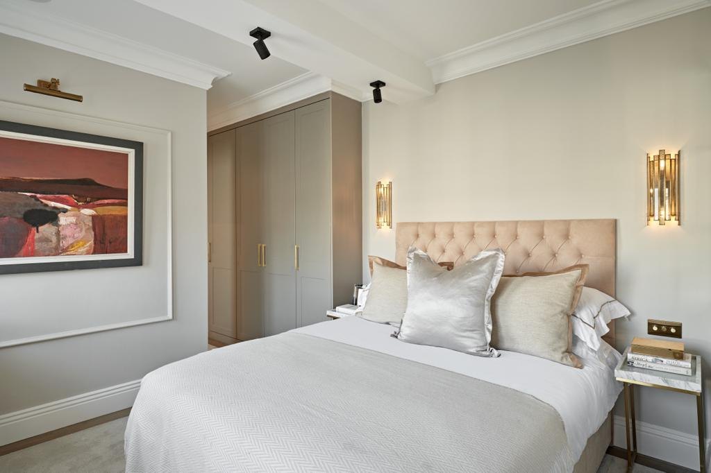 Bedroom refurbishment with fitted wardrobes and panelled headboard wall
