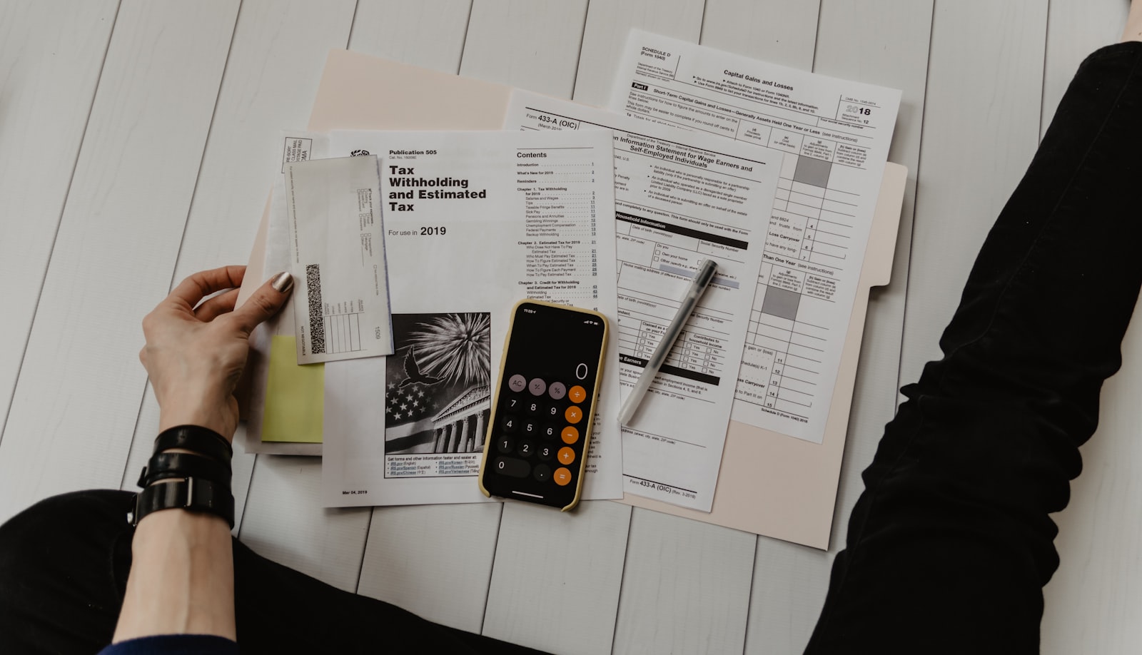 Comparing building quotes with paperwork and a calculator