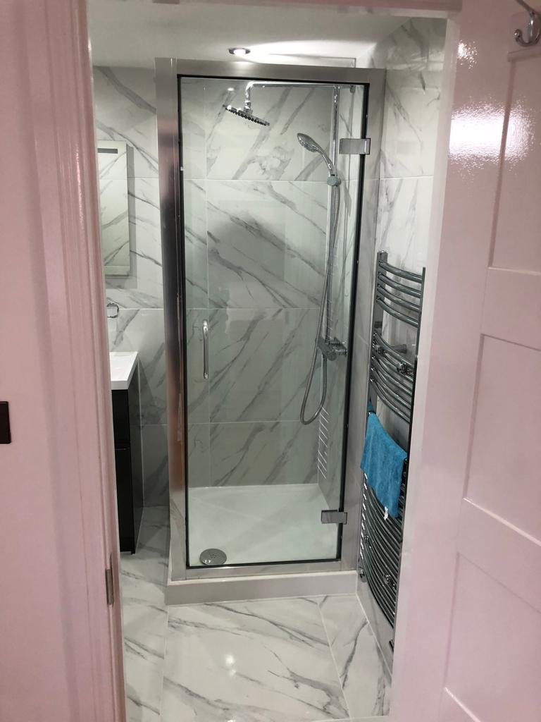 Loft en-suite walk-in shower with marble-effect porcelain tiles